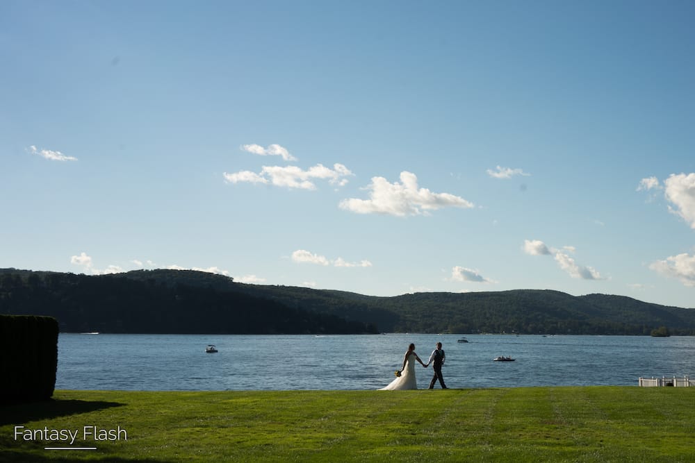 a bride and groom walking by lake Candlewood