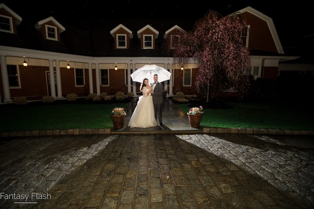 bride and groom in front of the hollow brook golf club
