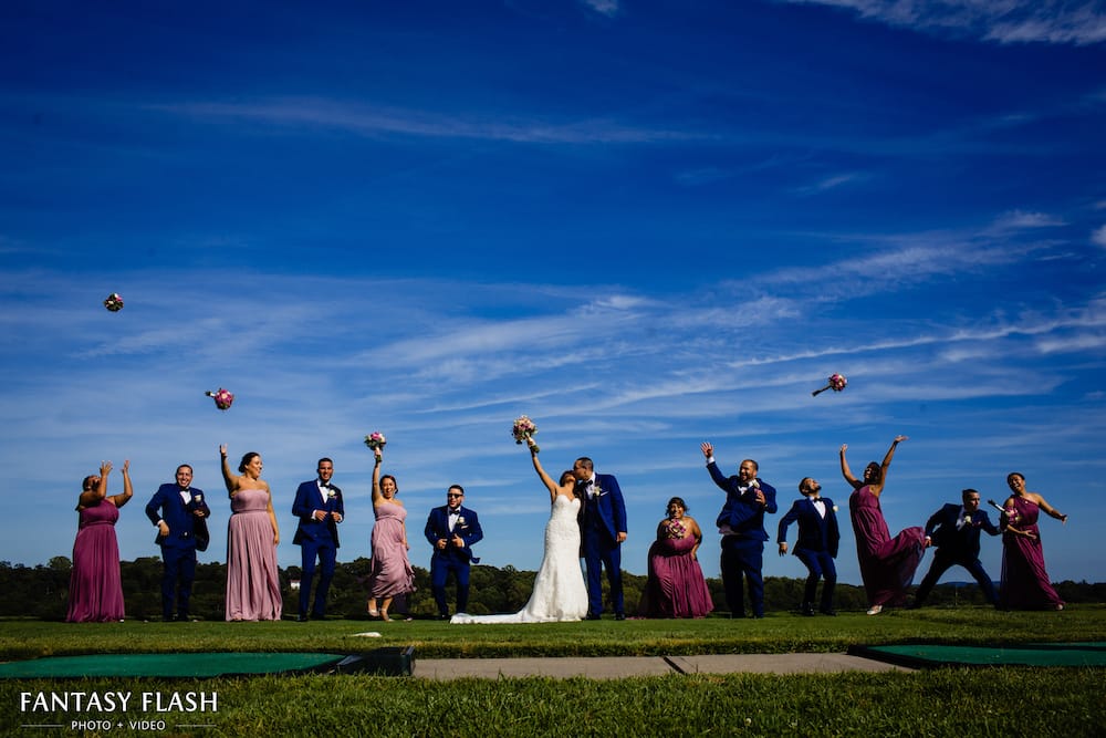 bride and groom with bridal party at New York Country Club
