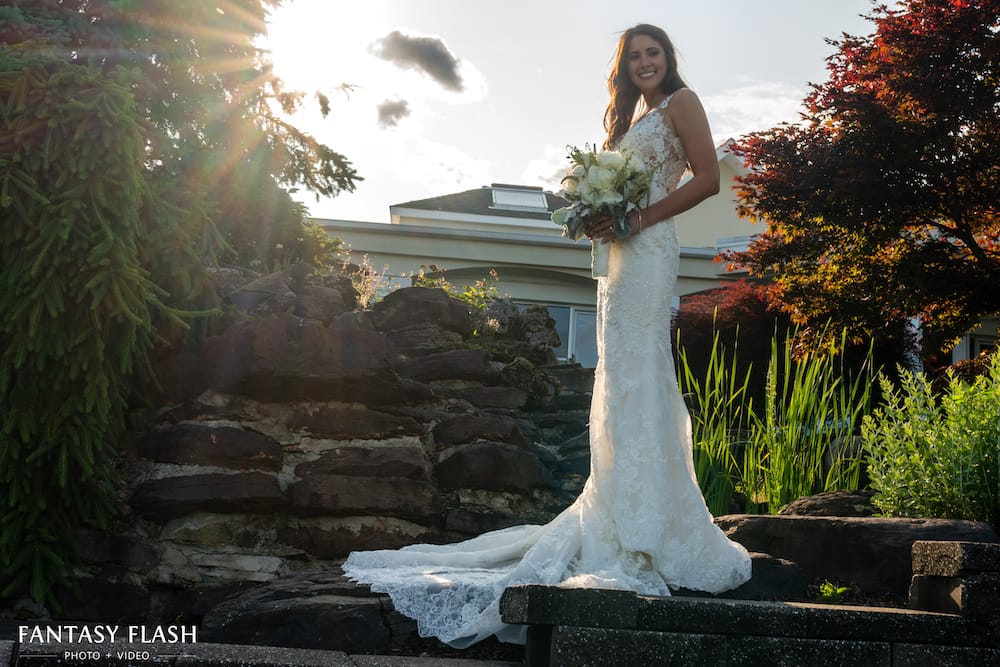 Bride posing for a wedding photo at New York Country Club